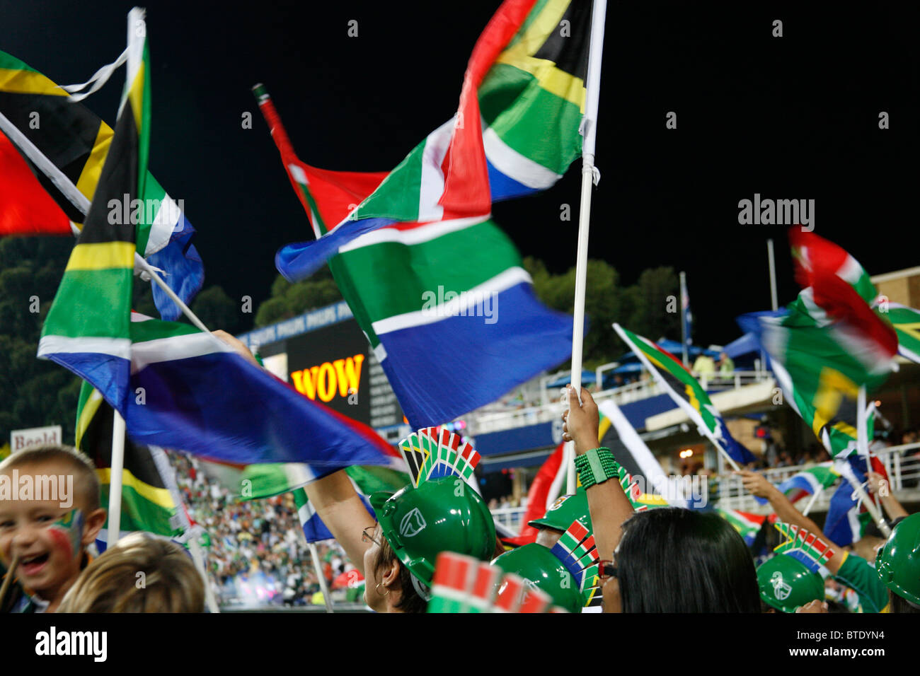 Cricket fans waving South African flags at a Pro20 international cricket match Stock Photo