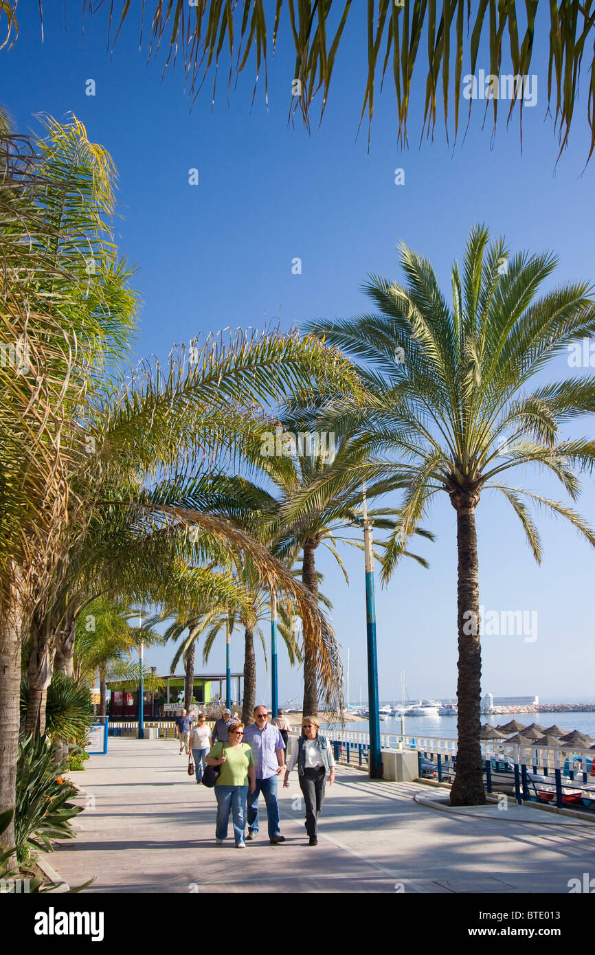 People walking along Marbella Paseo, Marbella, Spain Stock Photo