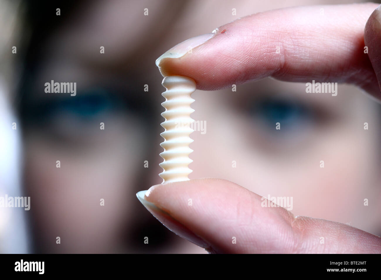 Experimental cutting of bone screws by a high pressure water jet. Stock Photo