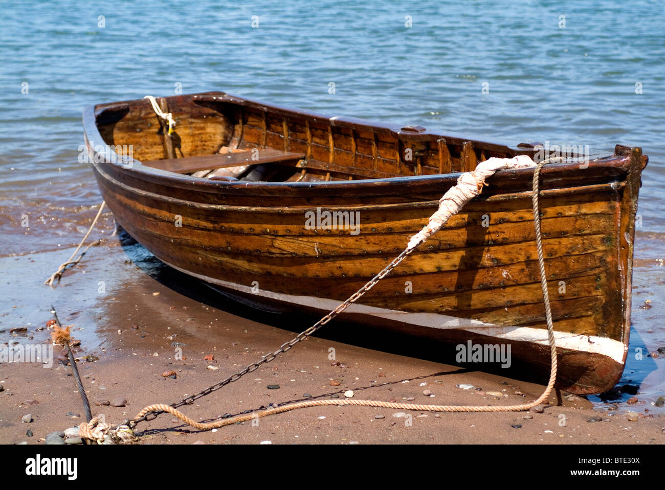 old wooden rowing boat on beach Stock Photo