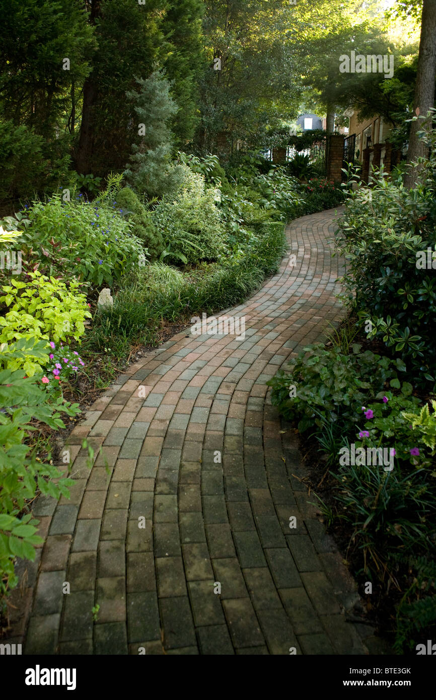 Brick path leading through the gardens. Stock Photo