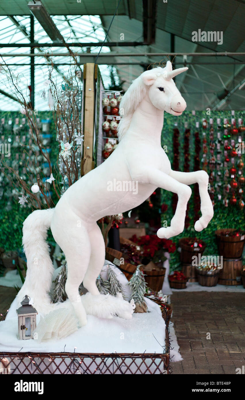 White Unicorn figure in garden centre Christmas display in UK Stock Photo
