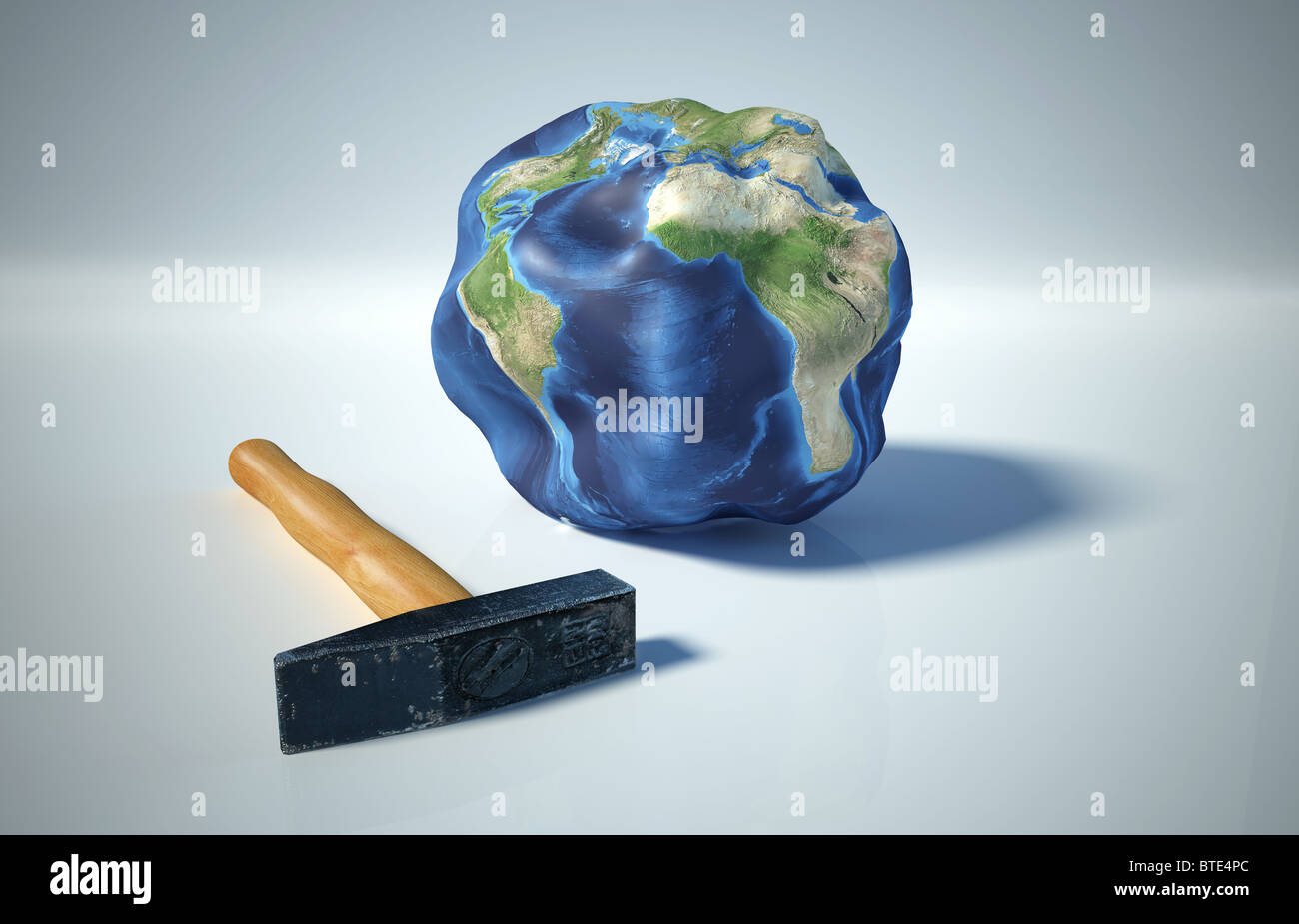 Planet earth heavily bruised, by a hammer Stock Photo