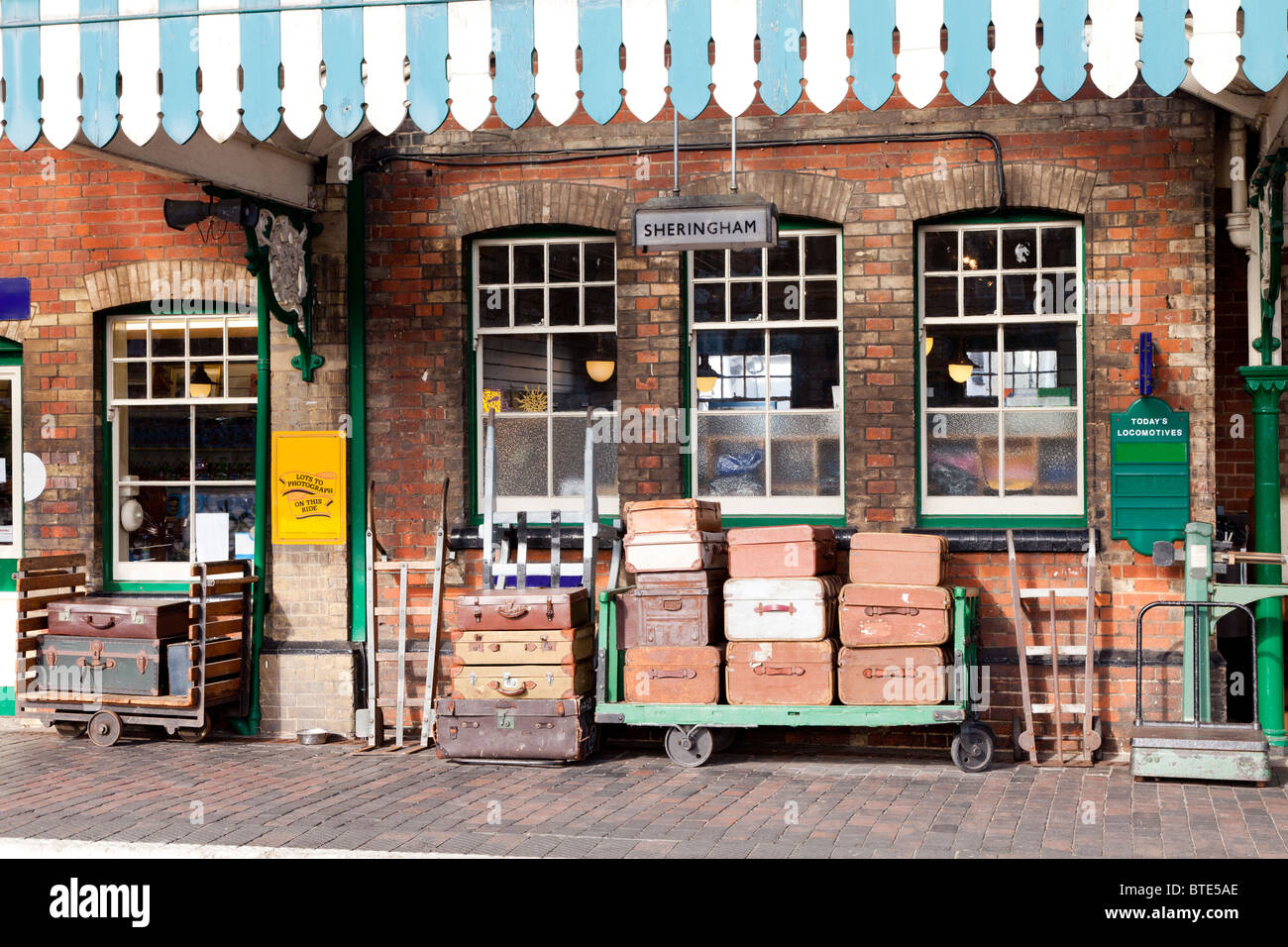 Old fashioned railway station with traditional luggage trollies and old style suitcases at Sheringham, Norfolk, England Stock Photo