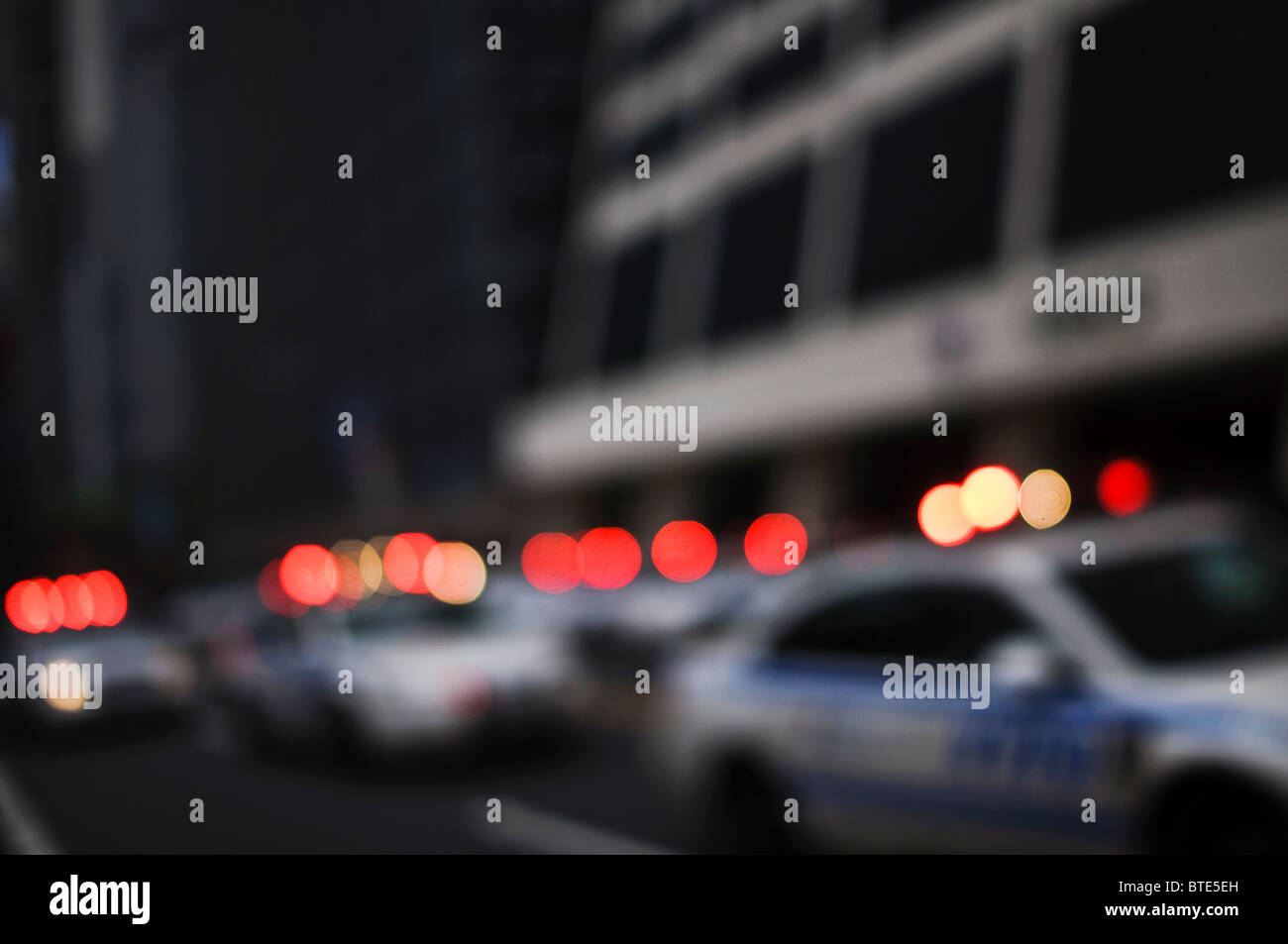 Police cars in New York City with sirens screaming and lights flashing. Image is deliberately out of focus. Stock Photo