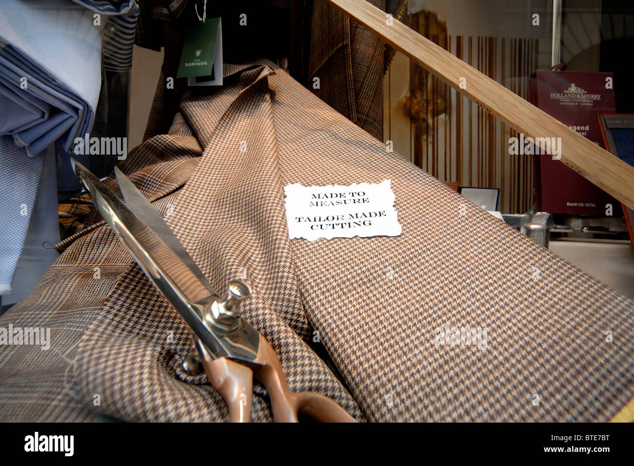 Made to measure sign in a traditional tailor's shop window in Bologna Italy. Stock Photo