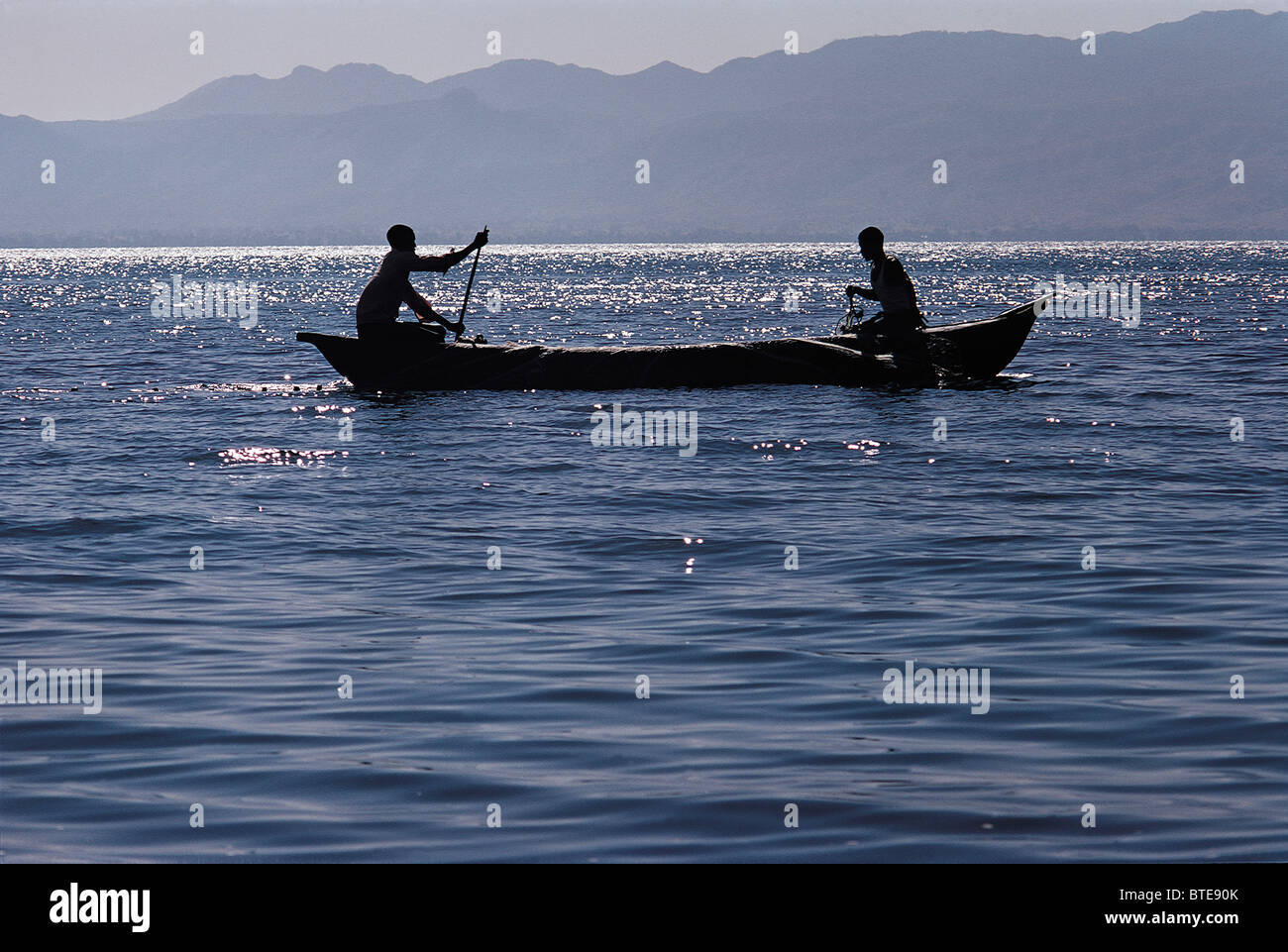 Two men paddling in a dugout canoe on Lake Malawi Stock Photo - Alamy