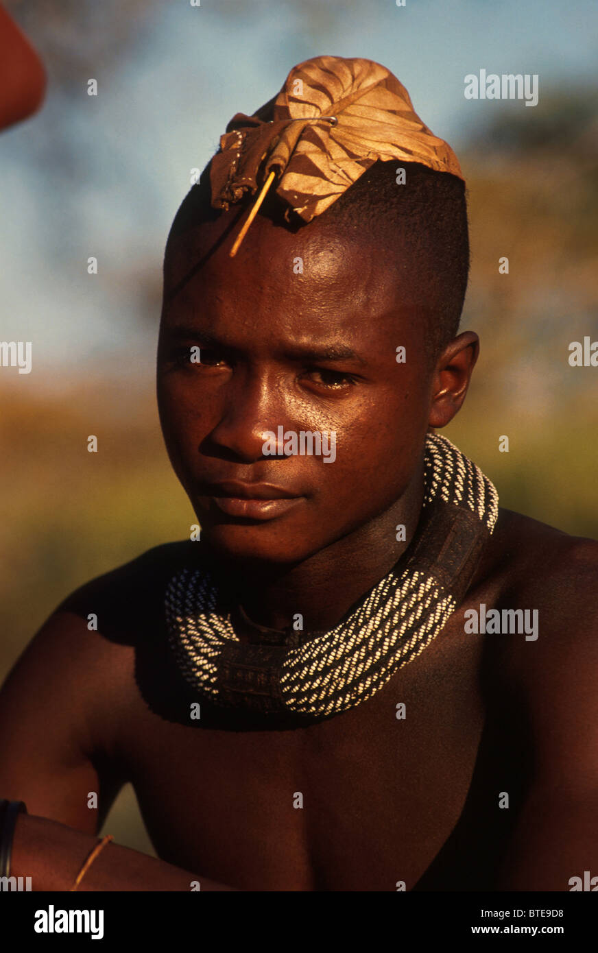 Himba youth with traditional head dress Stock Photo