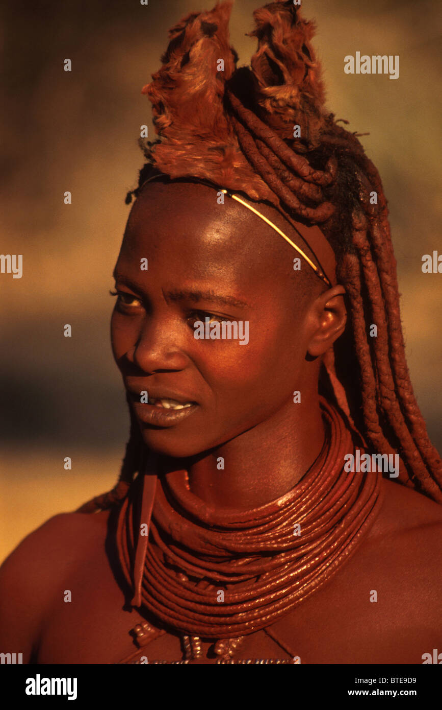 Himba woman with ochre and blood used to groom hair Stock Photo