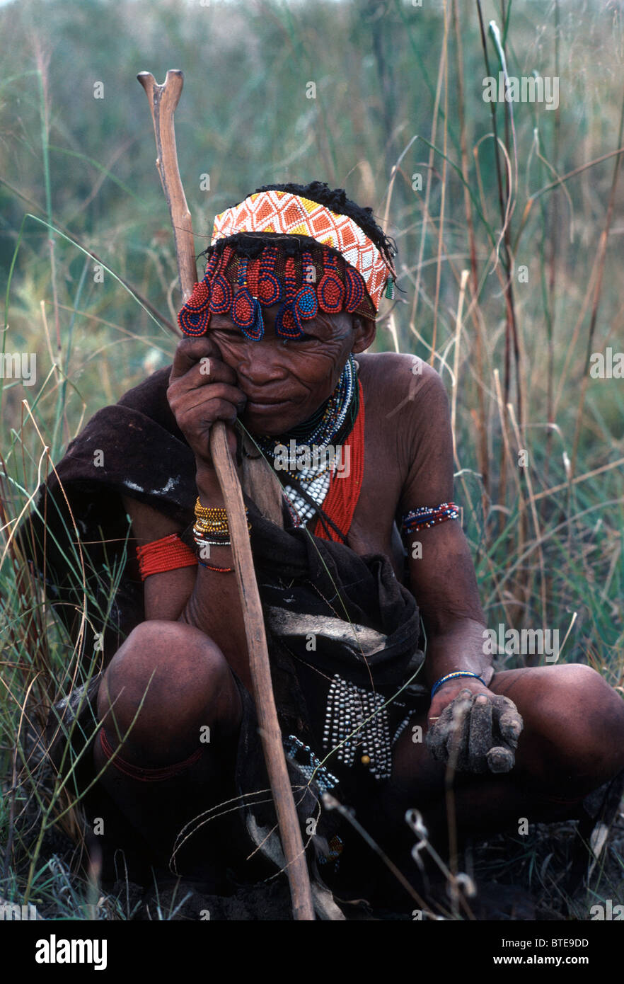 An elderly Kung Bushman/San woman with root digging stick used to dig for tubers Stock Photo