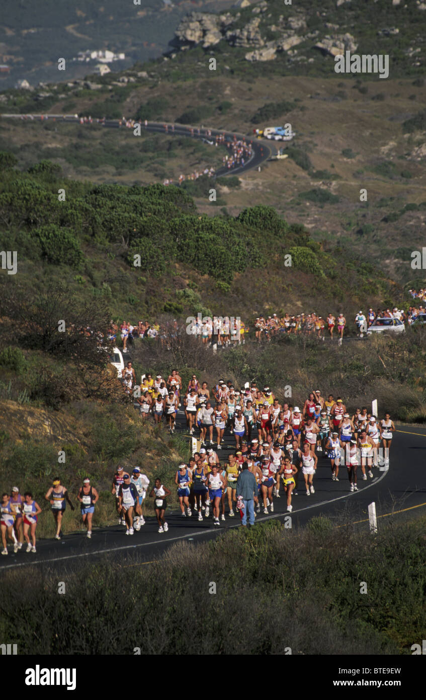 A large field of athletes wind their way up a steep hill on Oukaapseweg on the annual Two Oceans Marathon race Stock Photo
