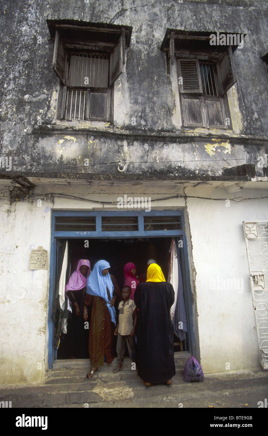 A group of local women and a young boy standing in shop doorway in Chake Chake, Pembe Island. Stock Photo