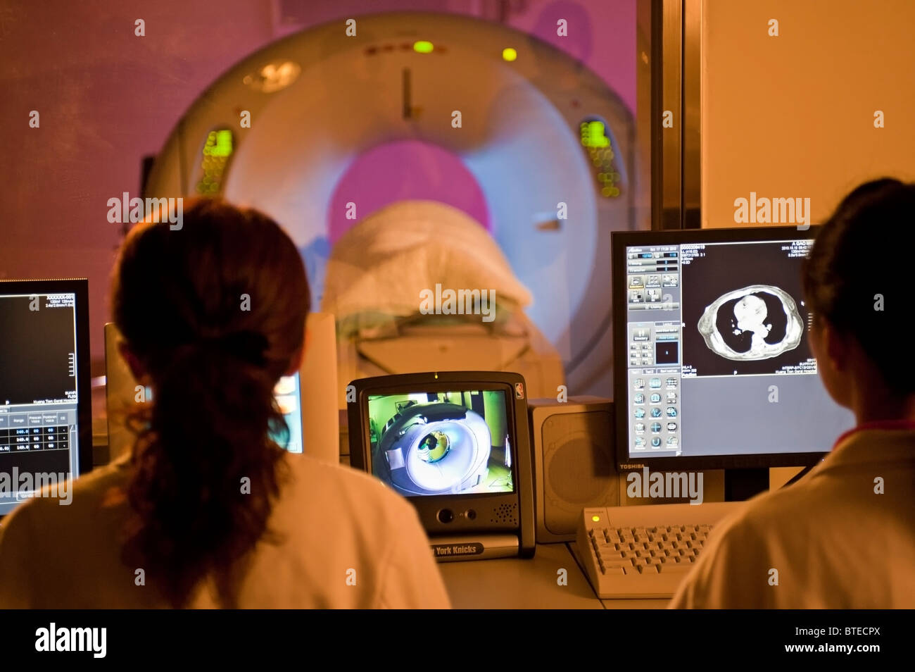 Doctors performing CAT scan, PET-CT diagnostic scan, on patient in hospital Stock Photo