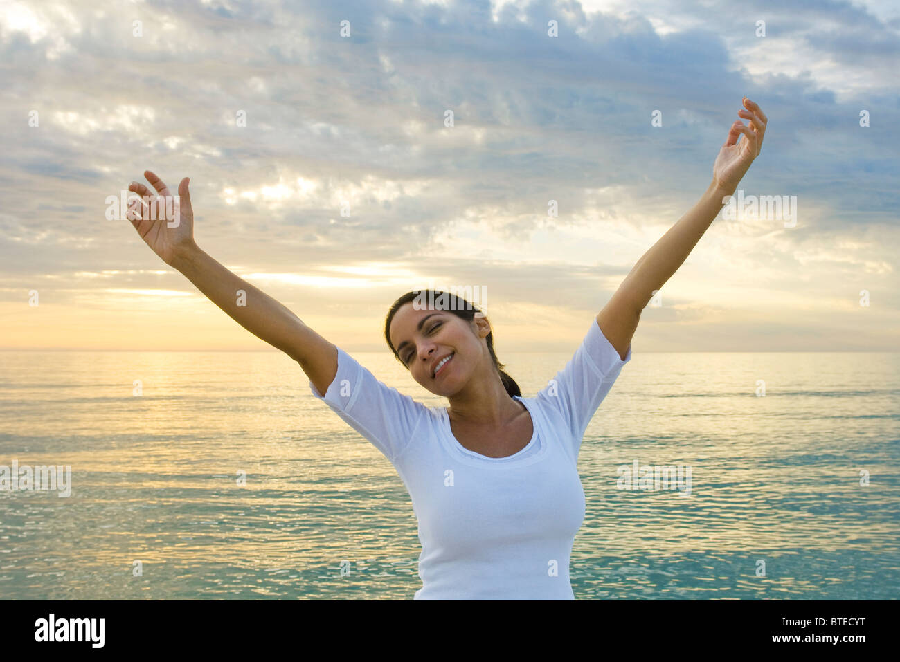 Woman stretching arms over head hi-res stock photography and images - Alamy