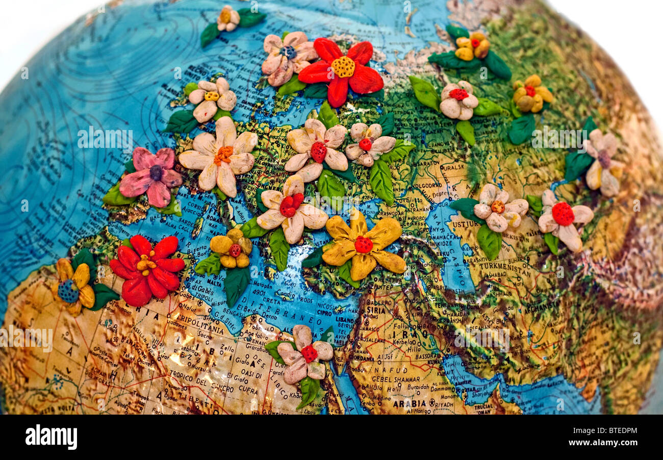 a colorful globe covered with flowers made in clay Stock Photo