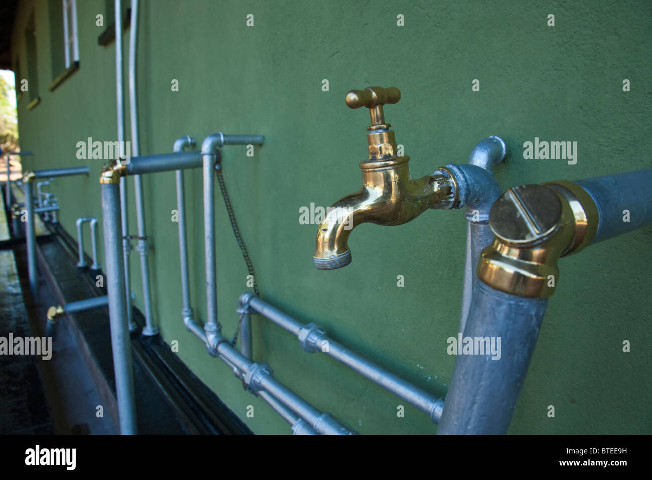 Shiny, clean taps and brass pipe fittings in Simuwini camp showing care