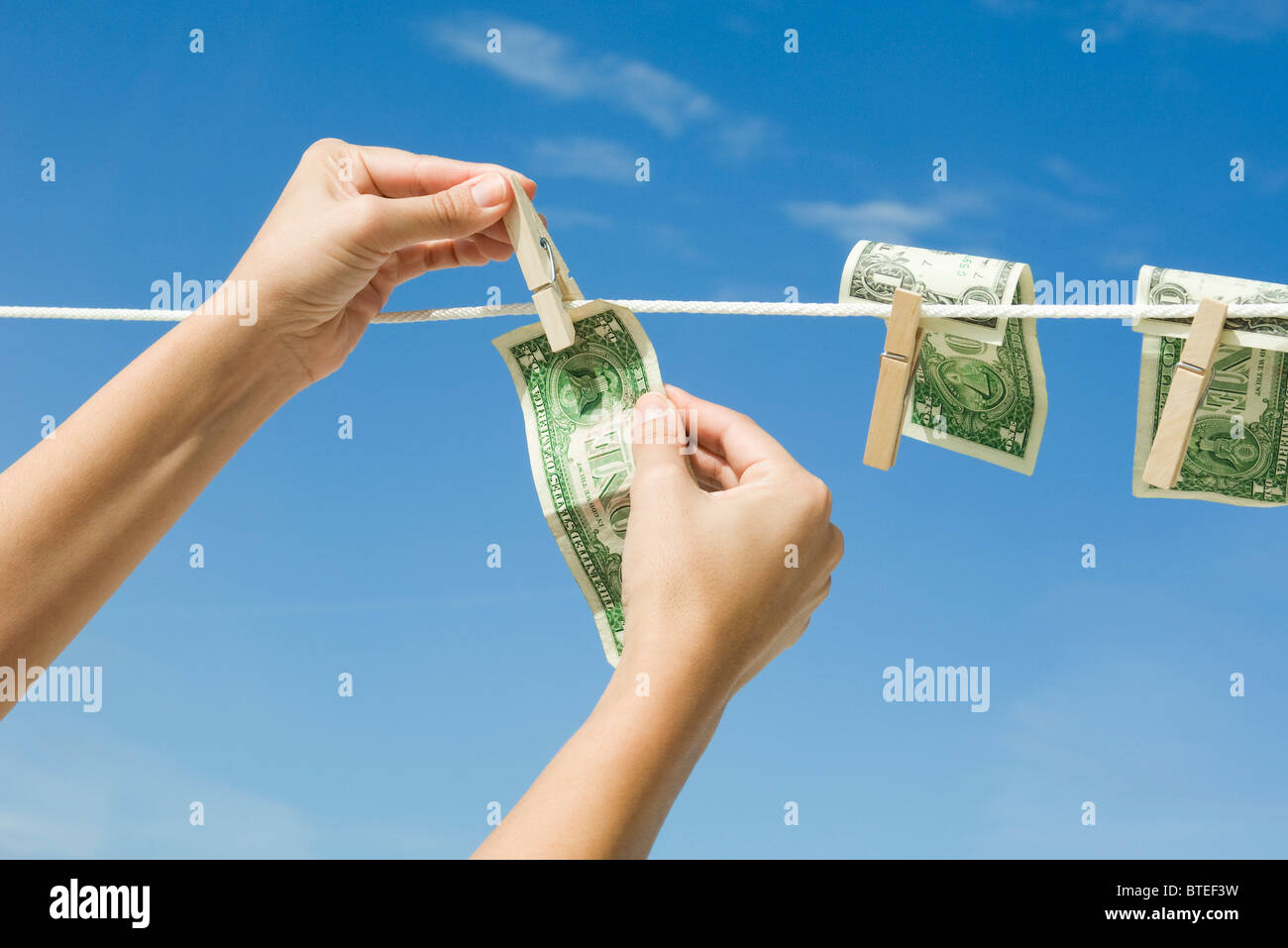 Hanging dollar bills on clothes-line Stock Photo