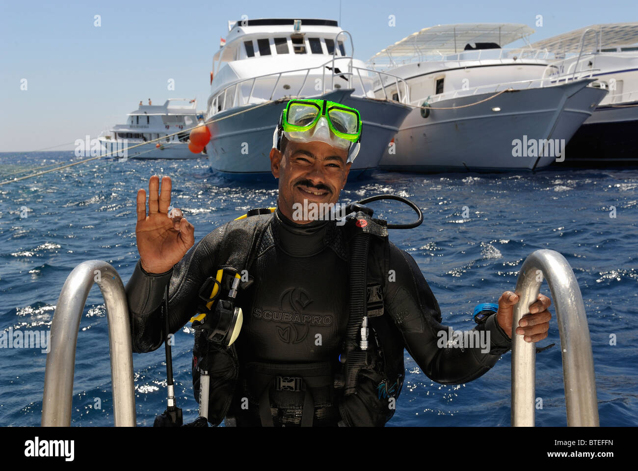Scuba diver climbing a ladder on a diving boat in the Red Sea Stock Photo Alamy