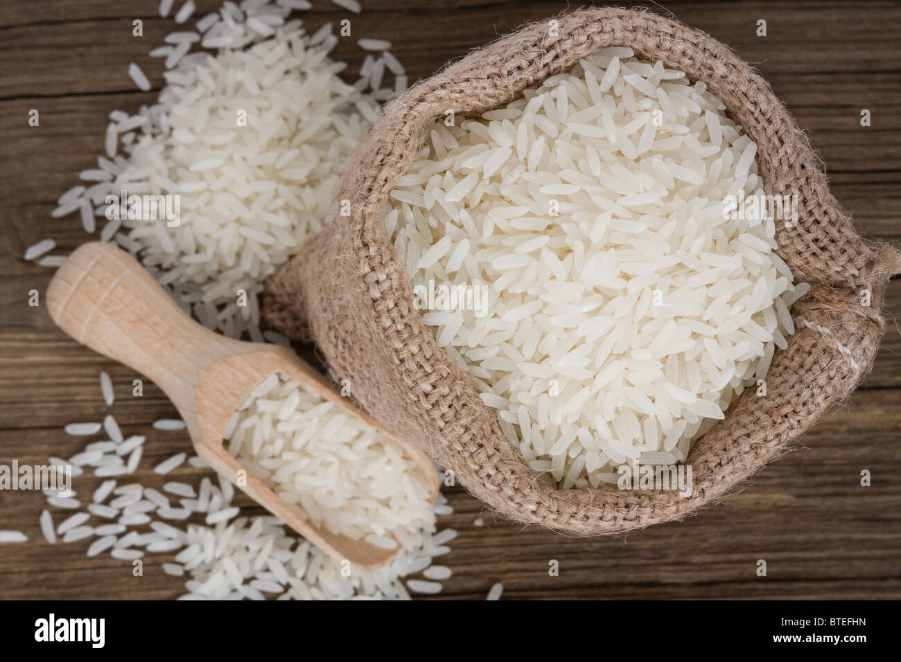 White long rice in burlap sack Stock Photo