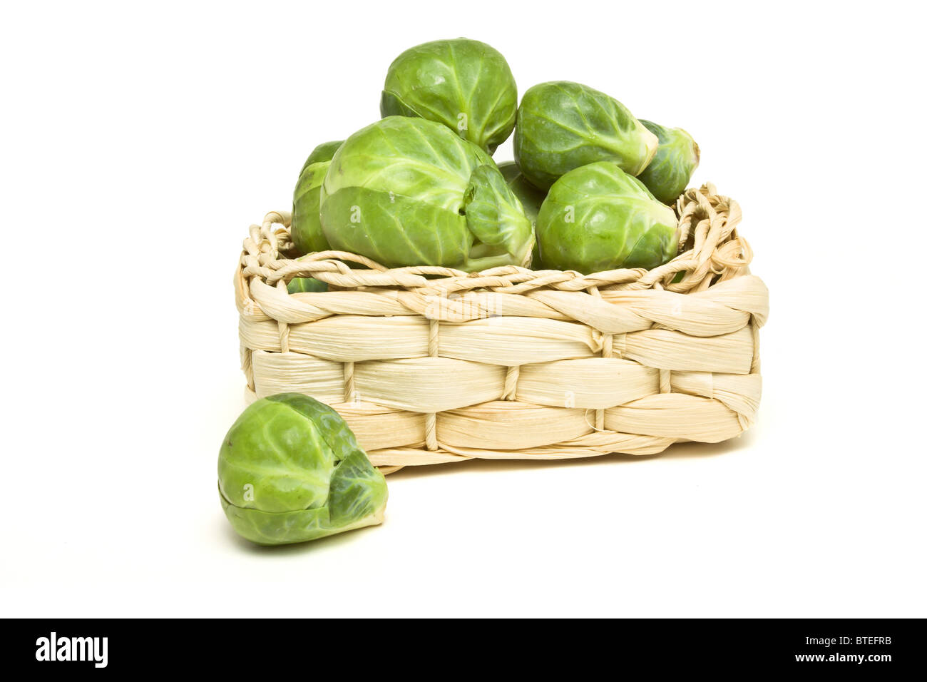 basket of Brussels Sprouts from low perspective isolated on white. Stock Photo