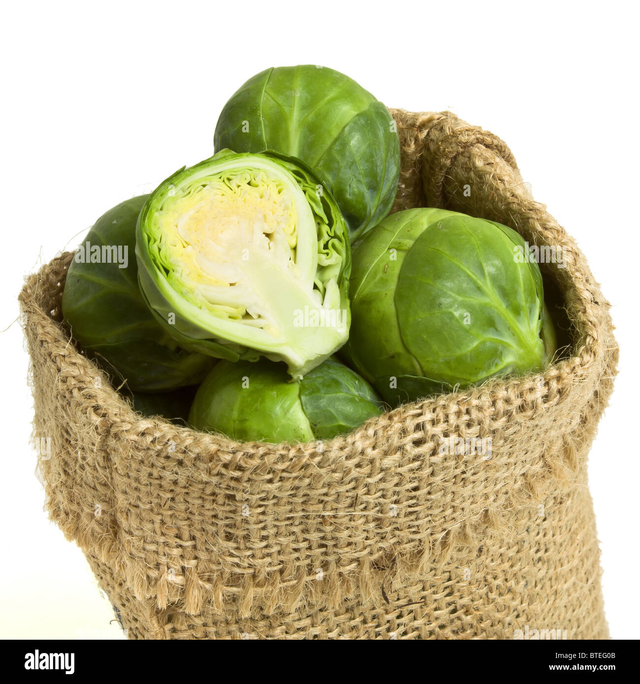Sack of Brussels Sprouts from low perspective isolated on white. Stock Photo