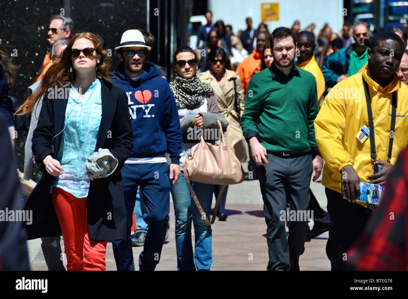 Crowd in the New York City, waling down the street on a sunny day. Stock Photo