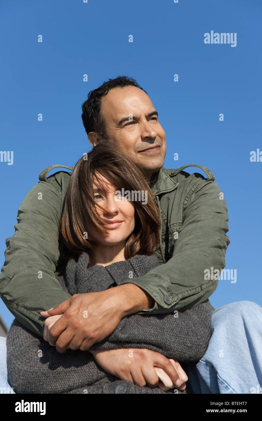 Woman and arms around man from behind hi-res stock photography and ...