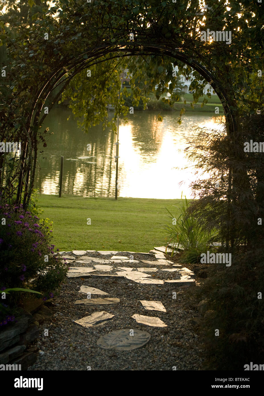Garden trellis and path leading to the lake Stock Photo Alamy