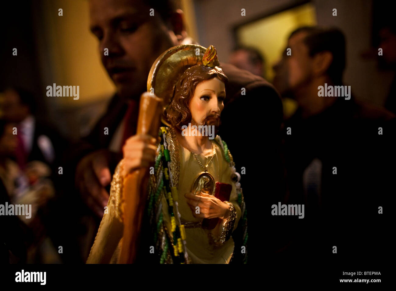 A pilgrim holds a sculpture of Saint Jude Thaddeus during a mass in San Hipolito church in Mexico City Stock Photo