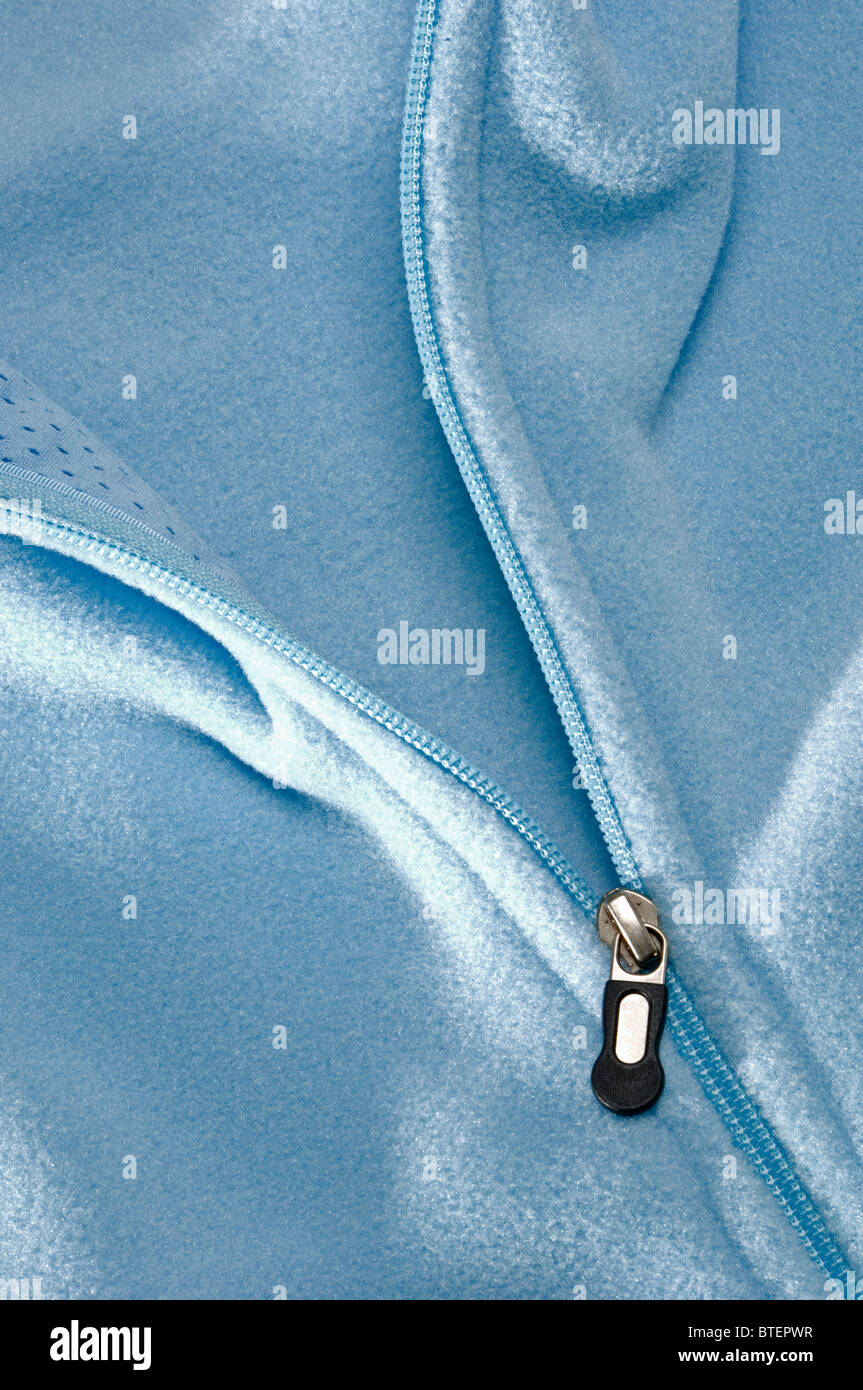 Close-up view of a blue pastel colored jacket and the zipper section opening Stock Photo