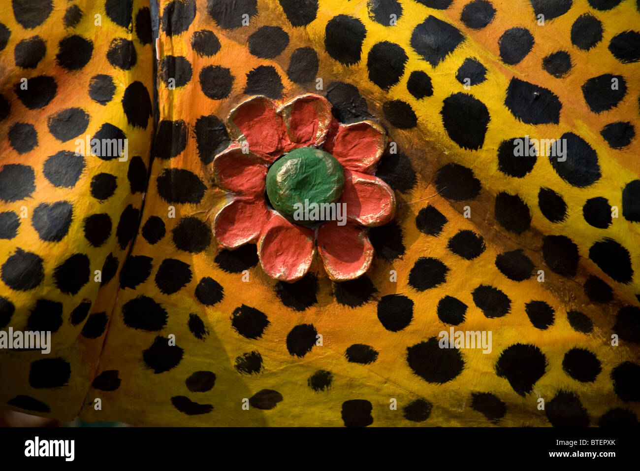 A red flower decorates a alebrije representing the mottled skin of a jaguar in Mexico City, October 27, 2010. Stock Photo