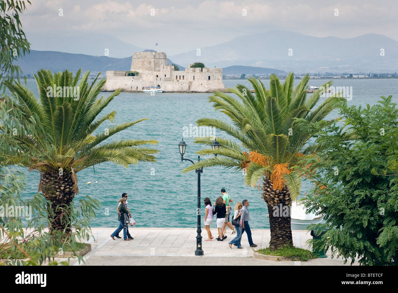 Nafplio, Greece. View across waterfront promenade towards Bourtzi Fortress Stock Photo