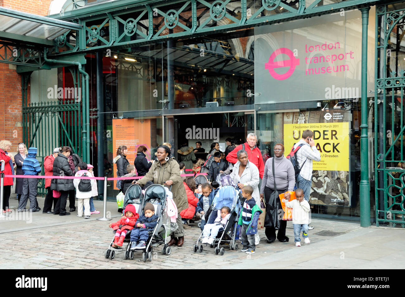 Mothers with children in pushchairs leaving the London Transport Museum in Covent Garden England Britain UK Stock Photo