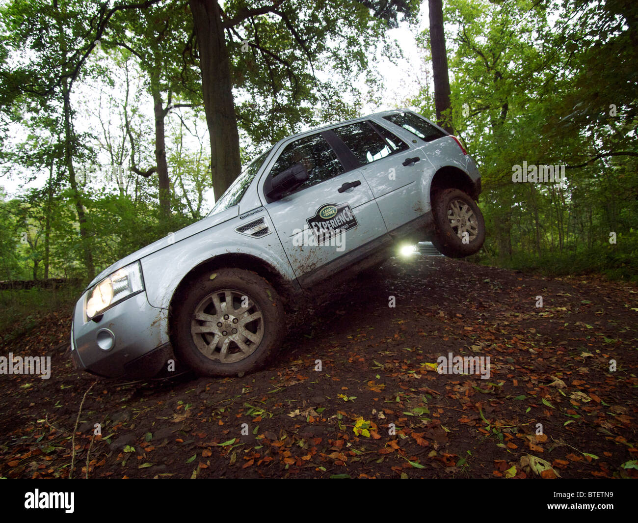 Landrover Freelander lifting a rear wheel while driving off road at Domaine d'Arthey, Belgium Stock Photo