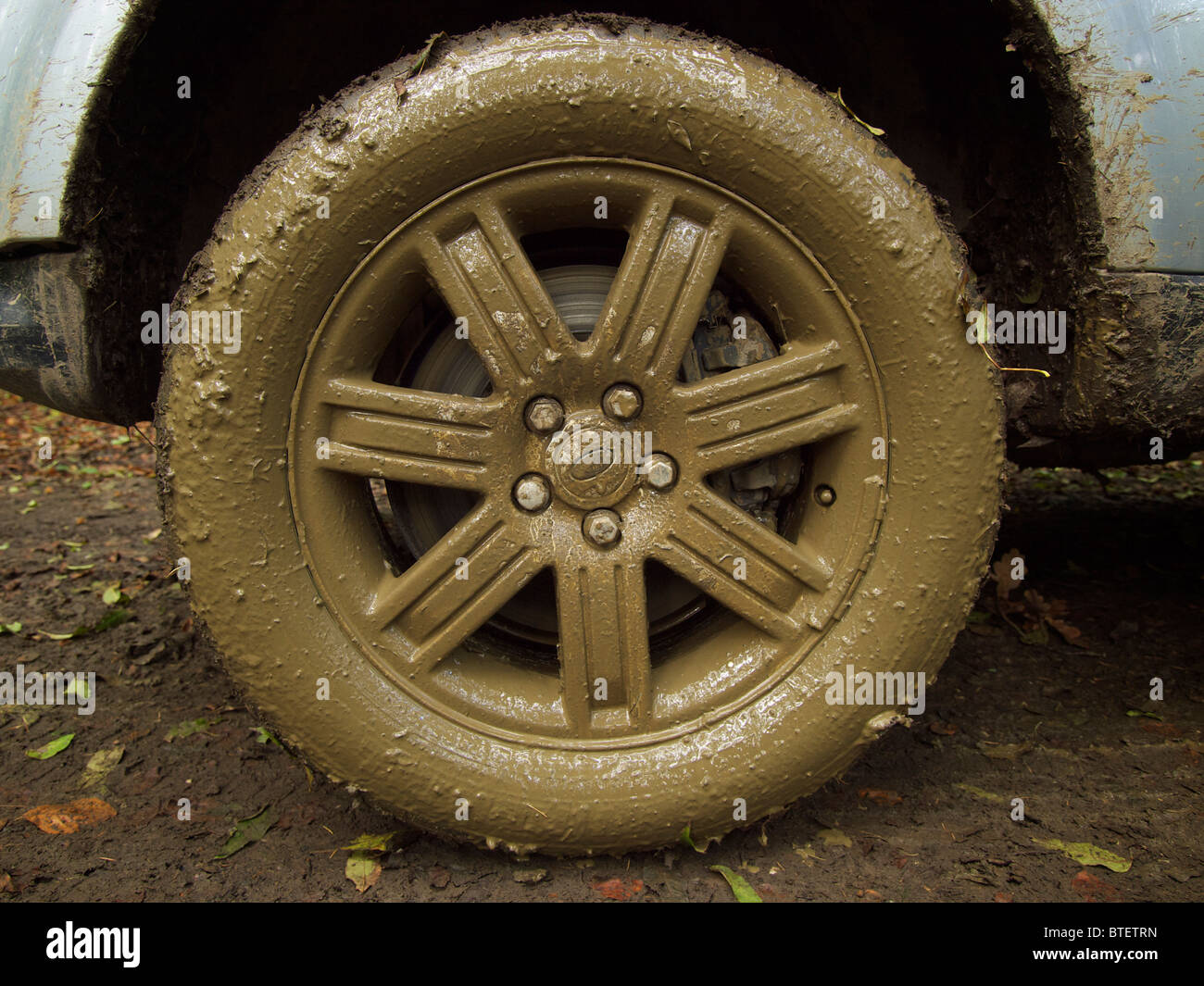 Very muddy wheel of a Range Rover Sport car after driving offroad Stock Photo