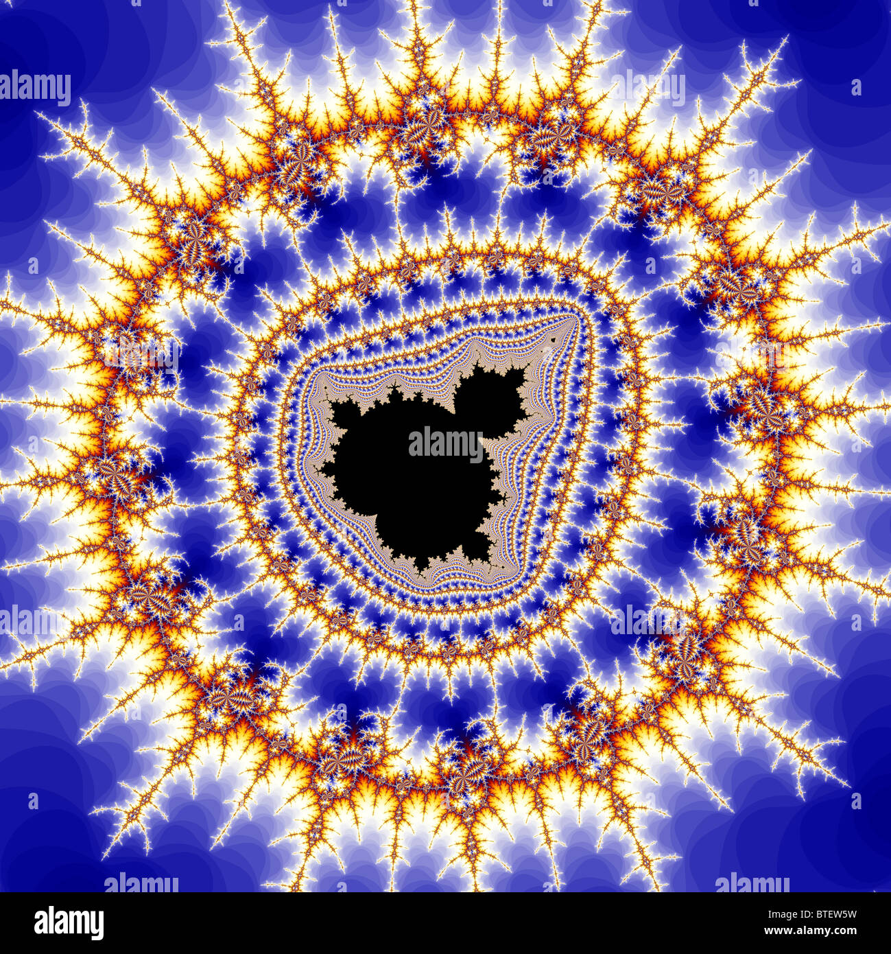 The Mandelbrot Set contains an infinite number of smaller copies of itself, usually surrounded by intricate patterns. Stock Photo