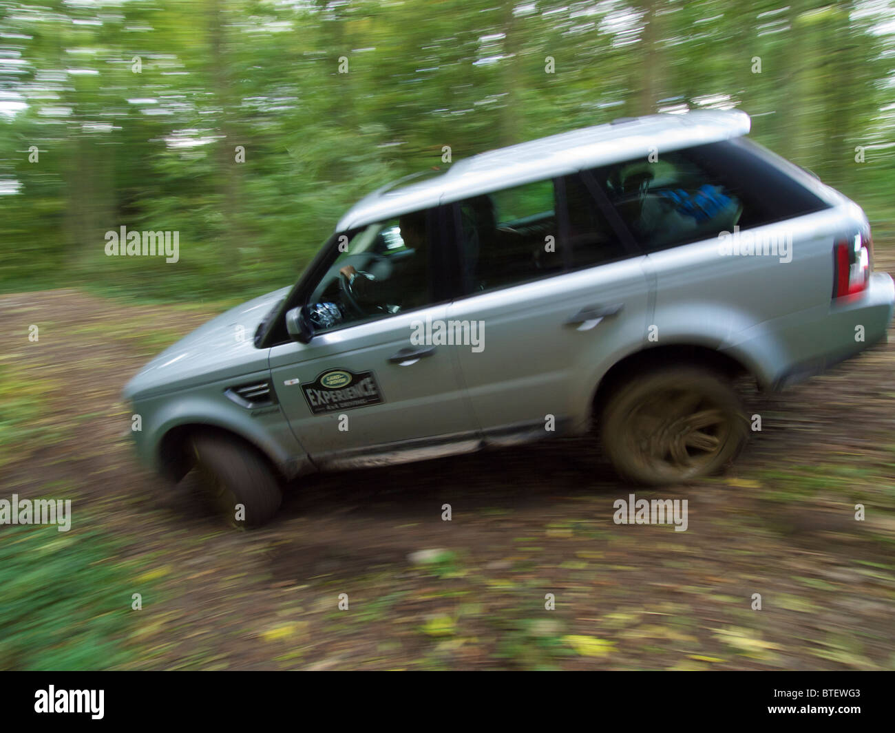Silver Range Rover Sport driving off road in Domaine d'Arthey estate with motion blur Stock Photo