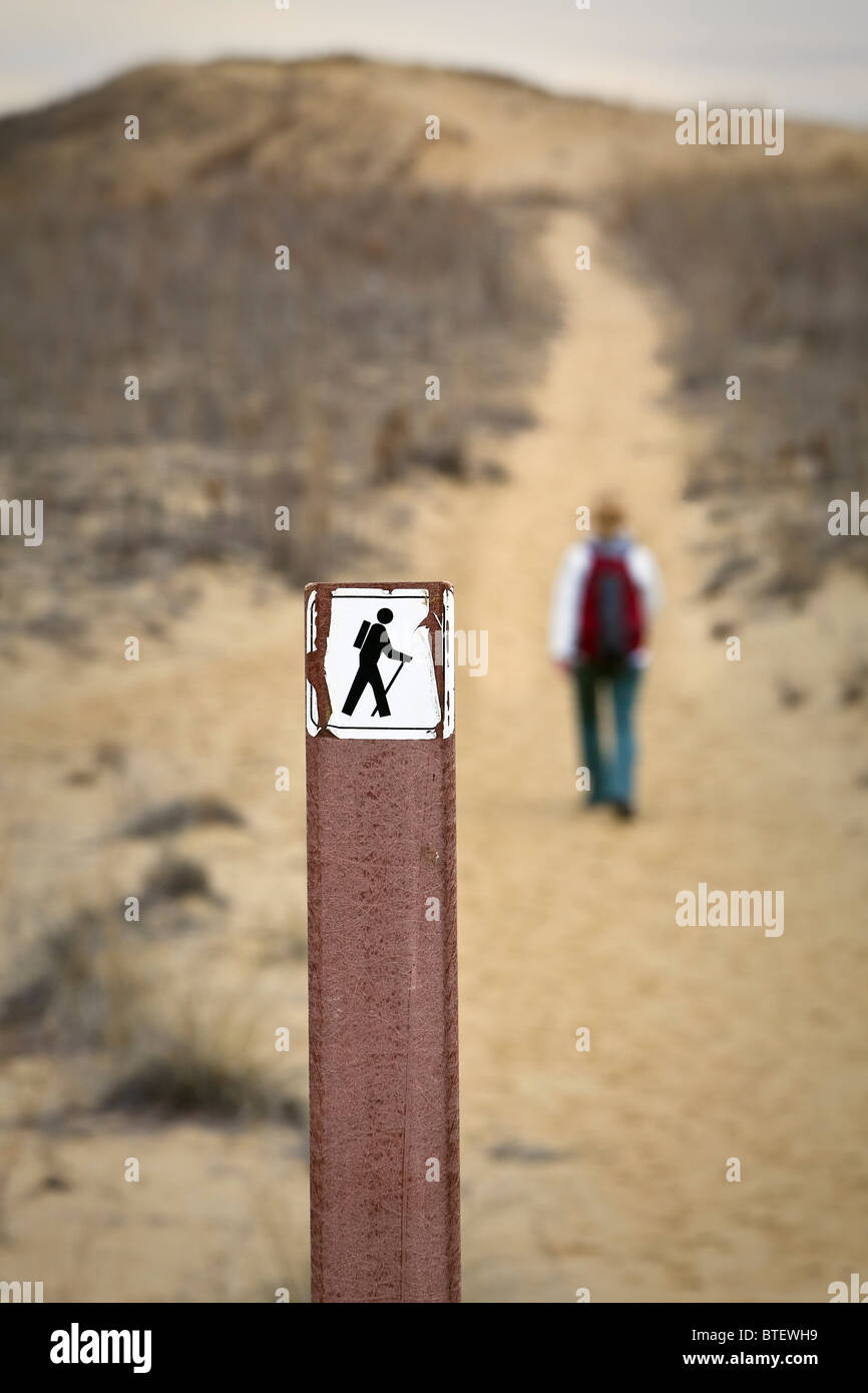 Hiking trail signpost, and woman hiking, Spirit Sands, Spruce Woods Provincial Park, Manitoba Stock Photo