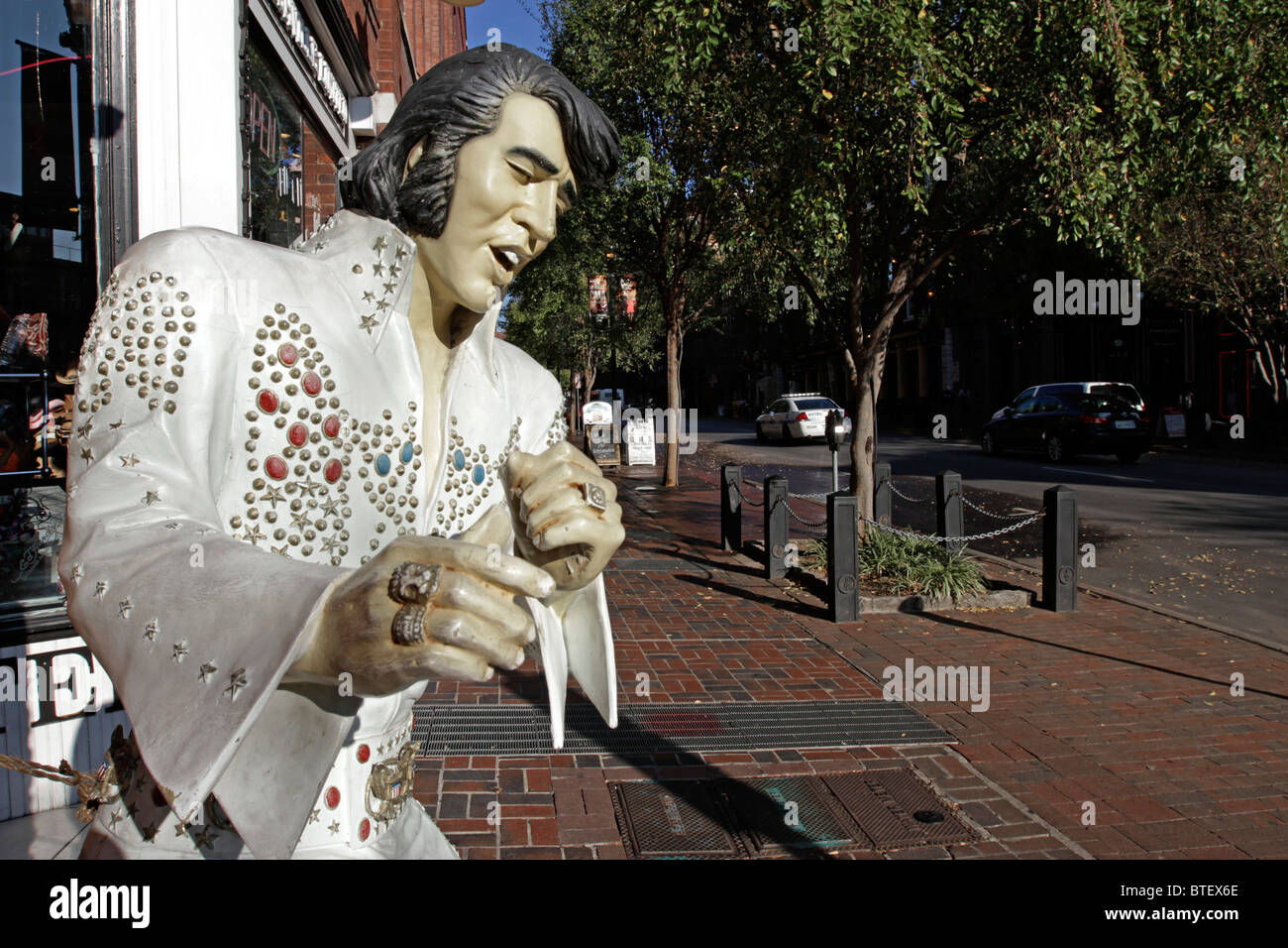 Life size statue of Elvis Presley adorning the front of a store in the historic district of