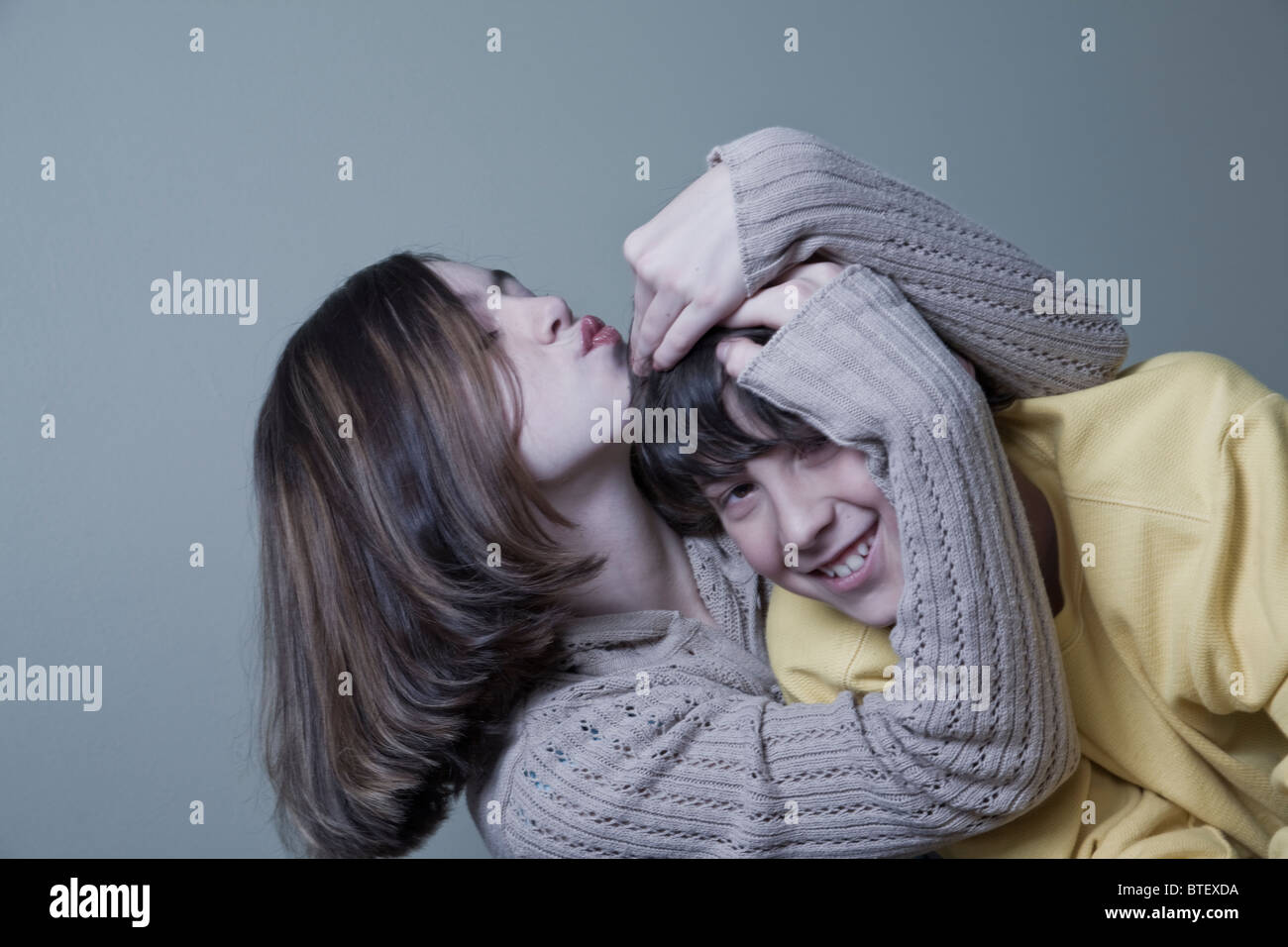 Girl hugging boy and puckering lips Stock Photo