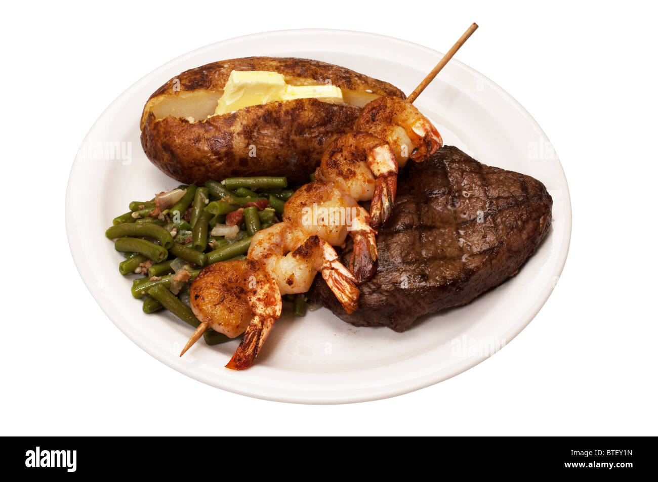 Sirloin steak with baked potato, green beans and shrimp on skewer