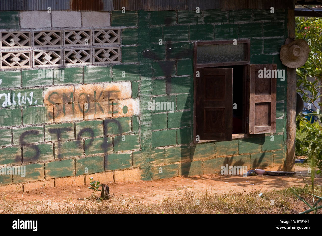 A sign advises travelers of the location of a rural store selling tobacco near Pai, Thailand. Stock Photo