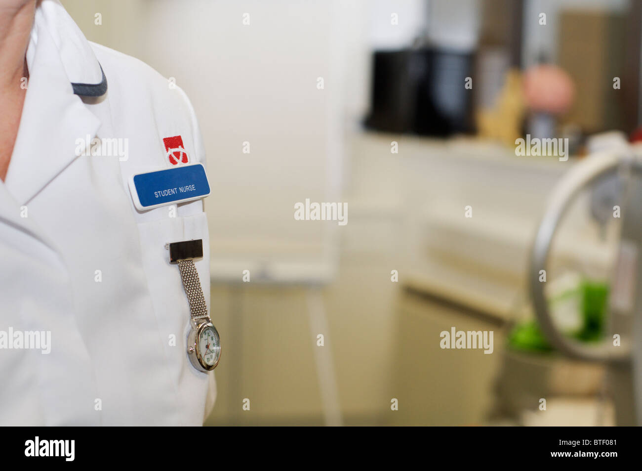 Close up of a nurse fob watch and university student nurse badge on a