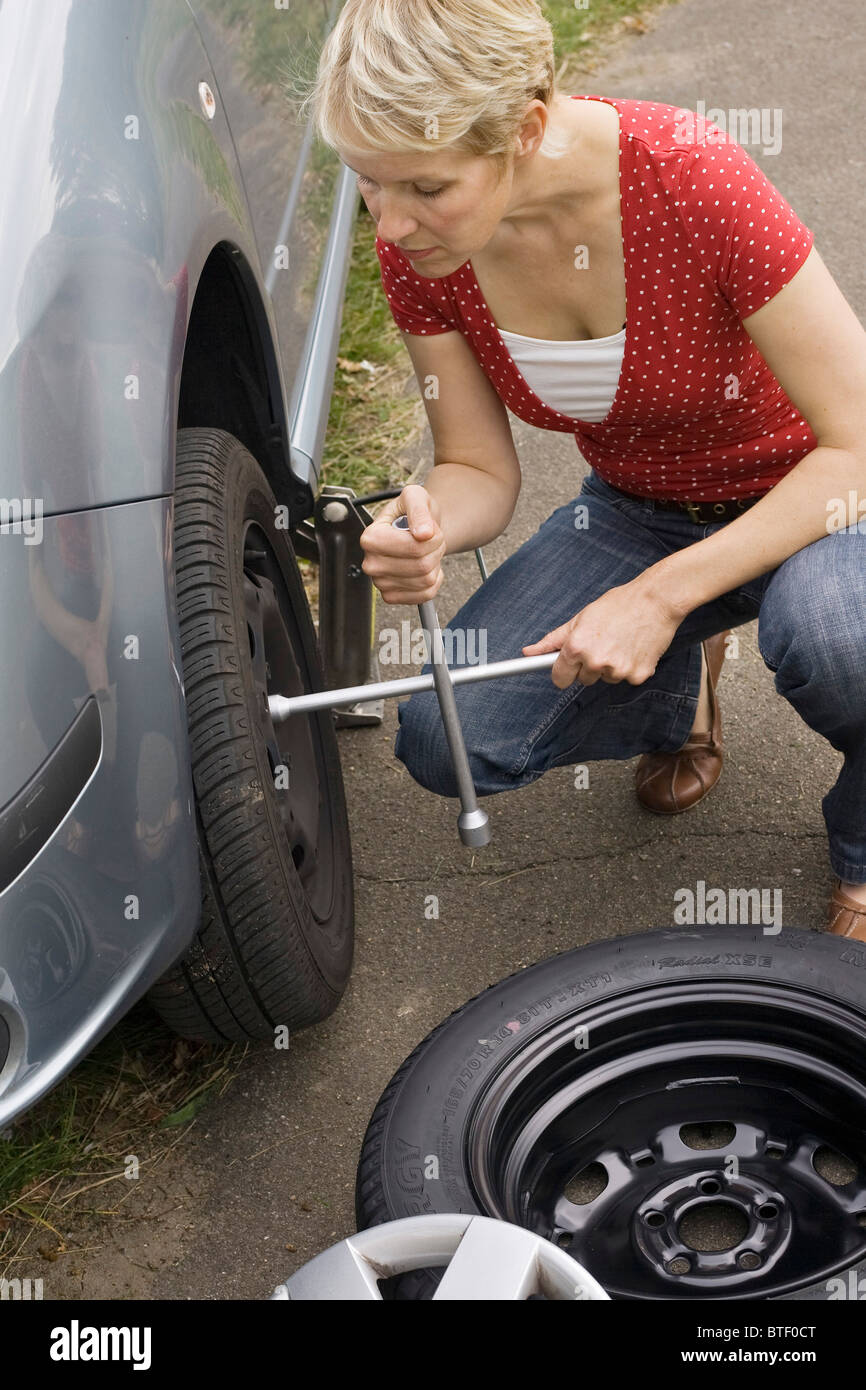 Female Driver Changing Car Tyre Hi Res Stock Photography And Images Alamy