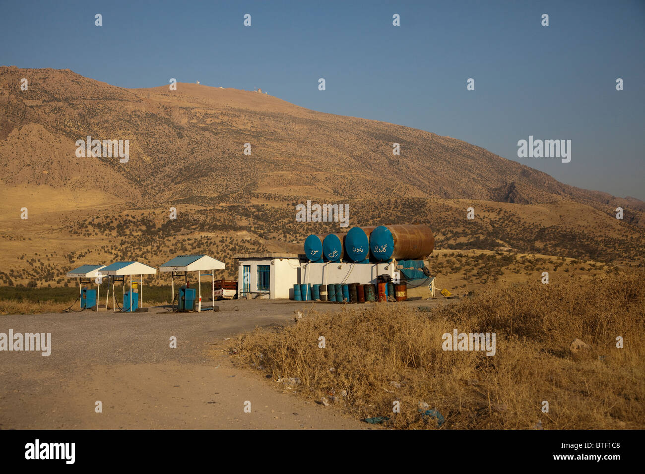 A small private filling station in Kurdistan region Northern Iraq. In KRI the fuel from internal national refineries provenience does not cover 100% of fuel consumption needs. Privately owned gas stations are authorized to import fuel and sell at a higher price compared to government owned gas stations. Stock Photo