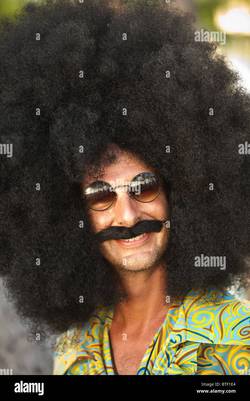 A man dressed in a giant afro wig during the annual Fantasy Fest October 27, 2010 in Key West, Florida. Stock Photo