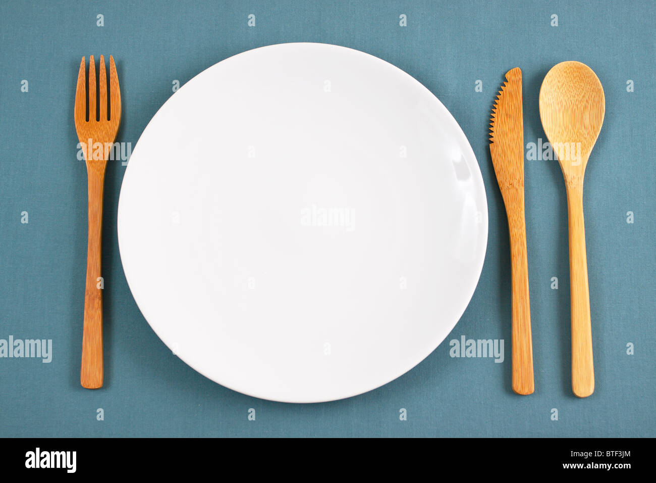 Bamboo placesetting with white plate Stock Photo