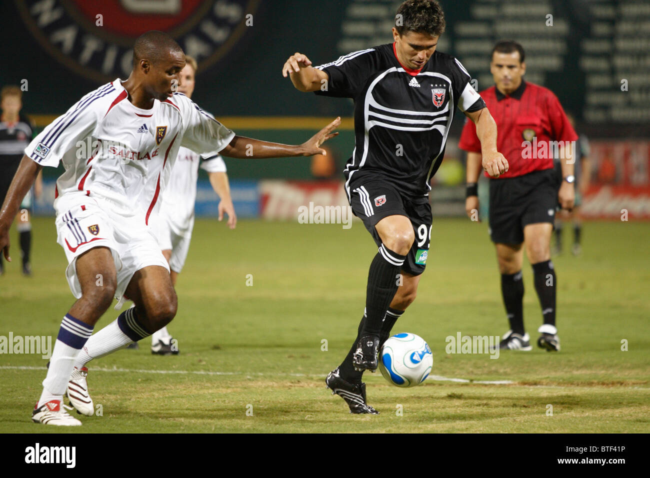 Jaime Moreno of DC United (r) controls the ball as Eddie Pope of Real Salt Lake (l) defends during a Major League Soccer match. Stock Photo