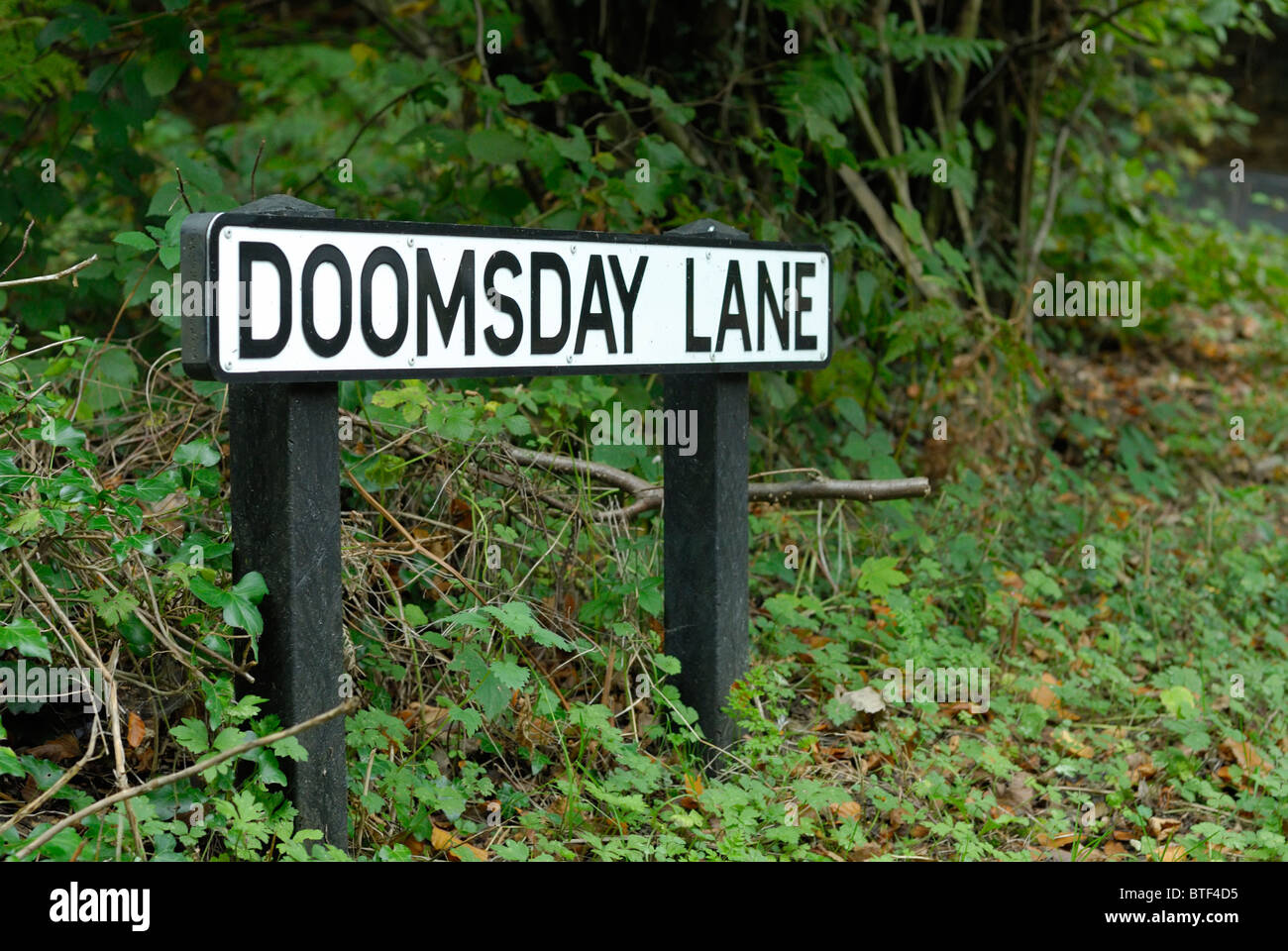 A signpost for Doomsday Lane near Horsham in West Sussex, England. Stock Photo