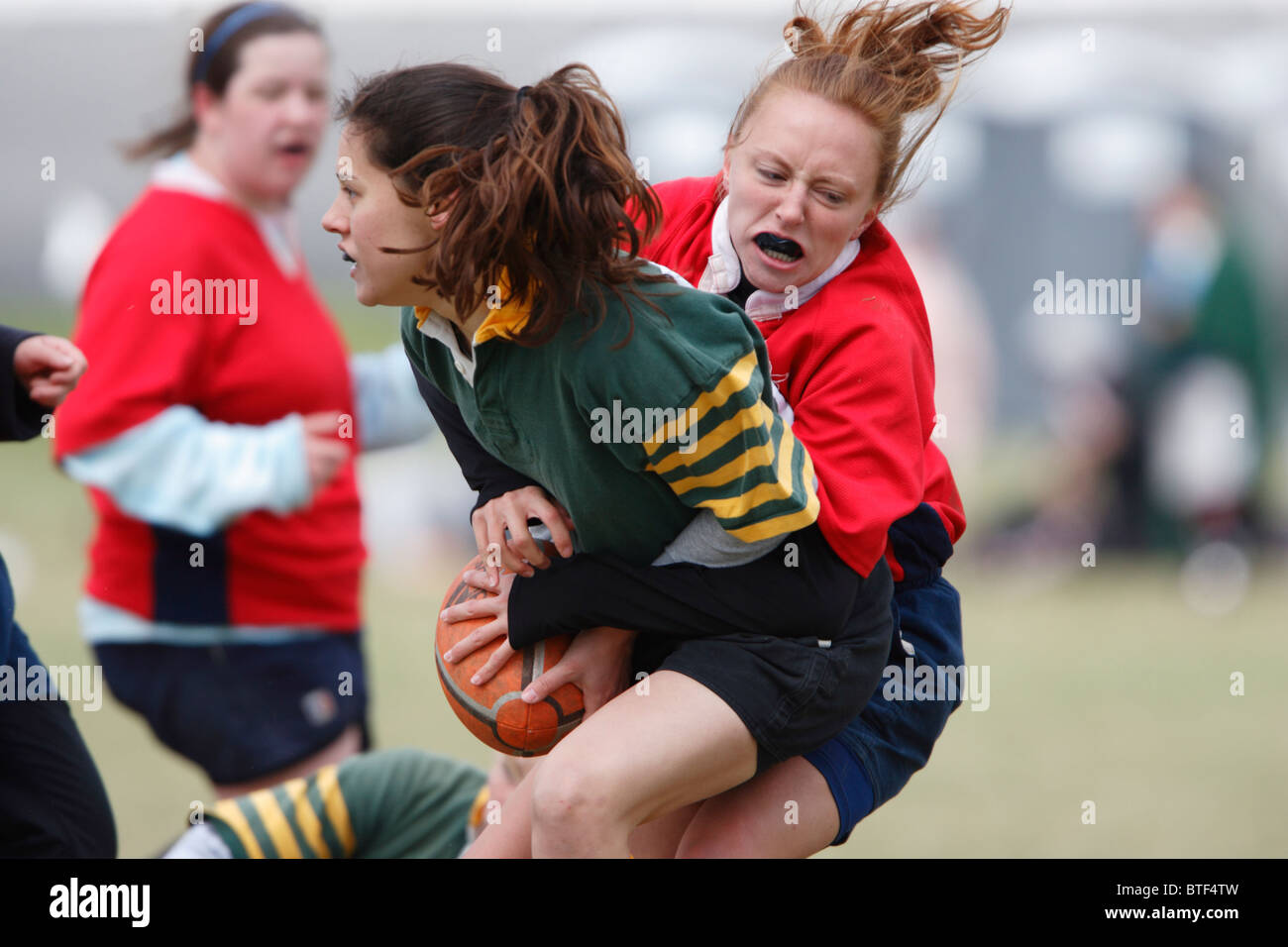 An American University player (r) makes a tackle against William and Mary during a women's rugby match. Stock Photo